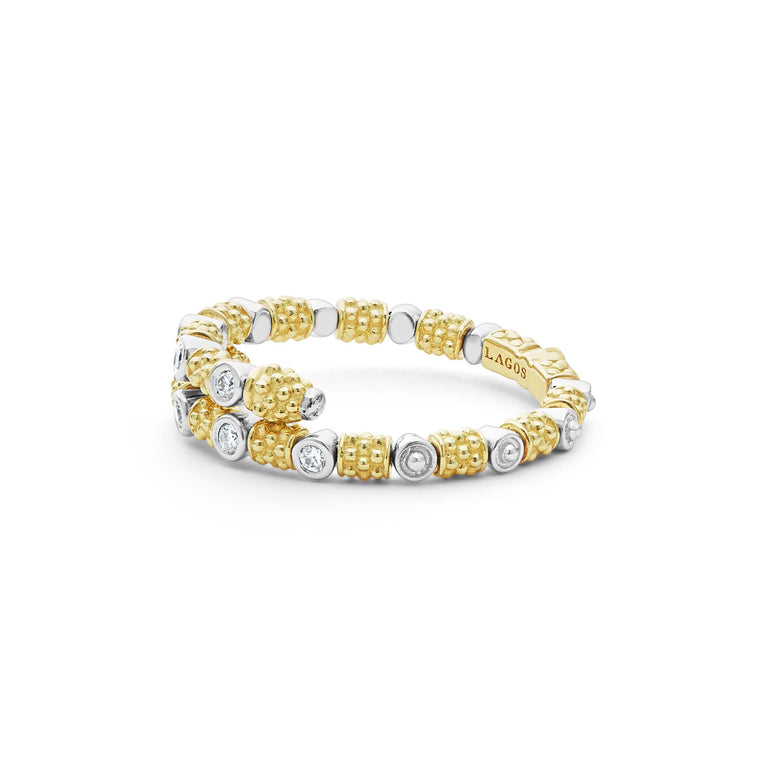 A side-view of An 18K Gold ring in the middle of a white background featuring diamonds surrounded by 18k gold superfine Caviar beading in a wrap design.