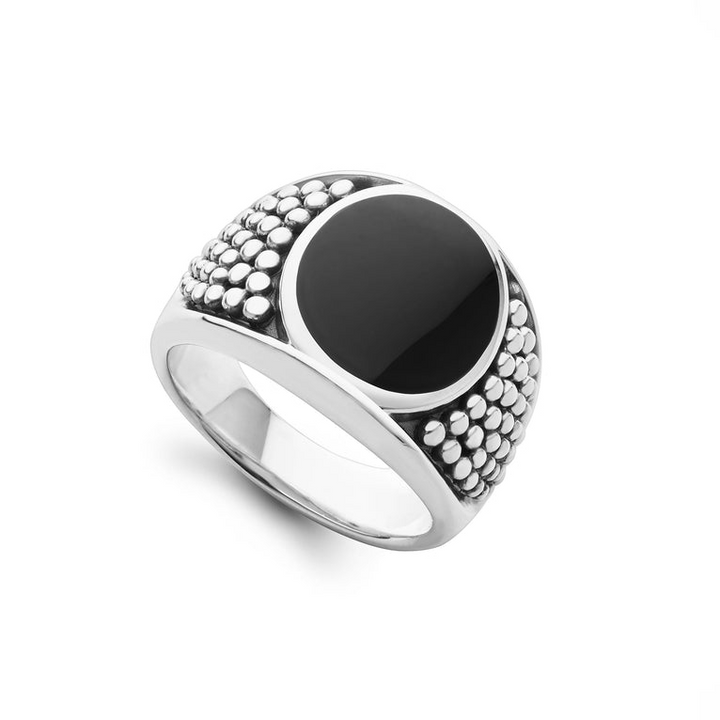 A sterling silver ring angled to the right in the middle of a white background featuring a black agate gemstone and sterling silver Caviar beading