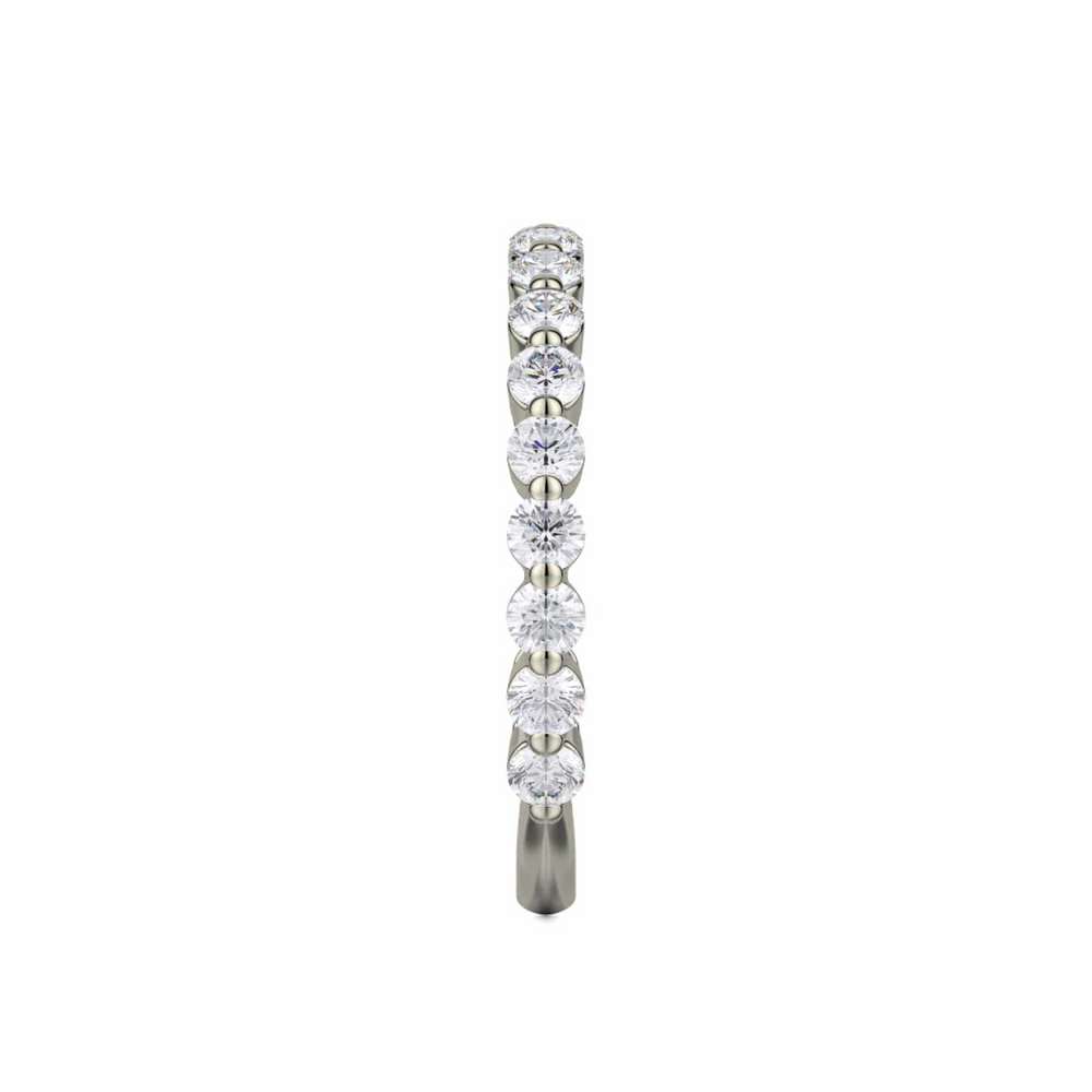 A side profile view of a white gold wedding band against a white background. The ring features a 3/4 eternity style with prong-set round diamonds.