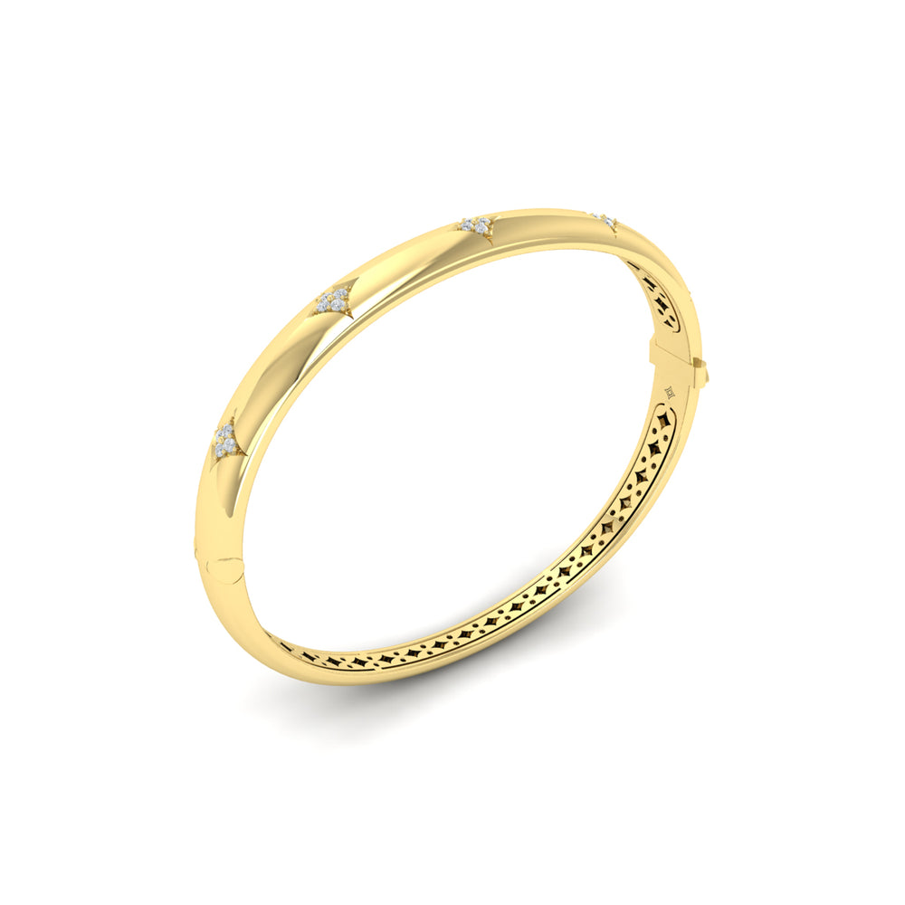 An angled view of a yellow-gold bracelet is set against a white background, showing the inside of the bracelet. The bracelet features a diamond-set star design across the yellow gold bangle with a clasp secured