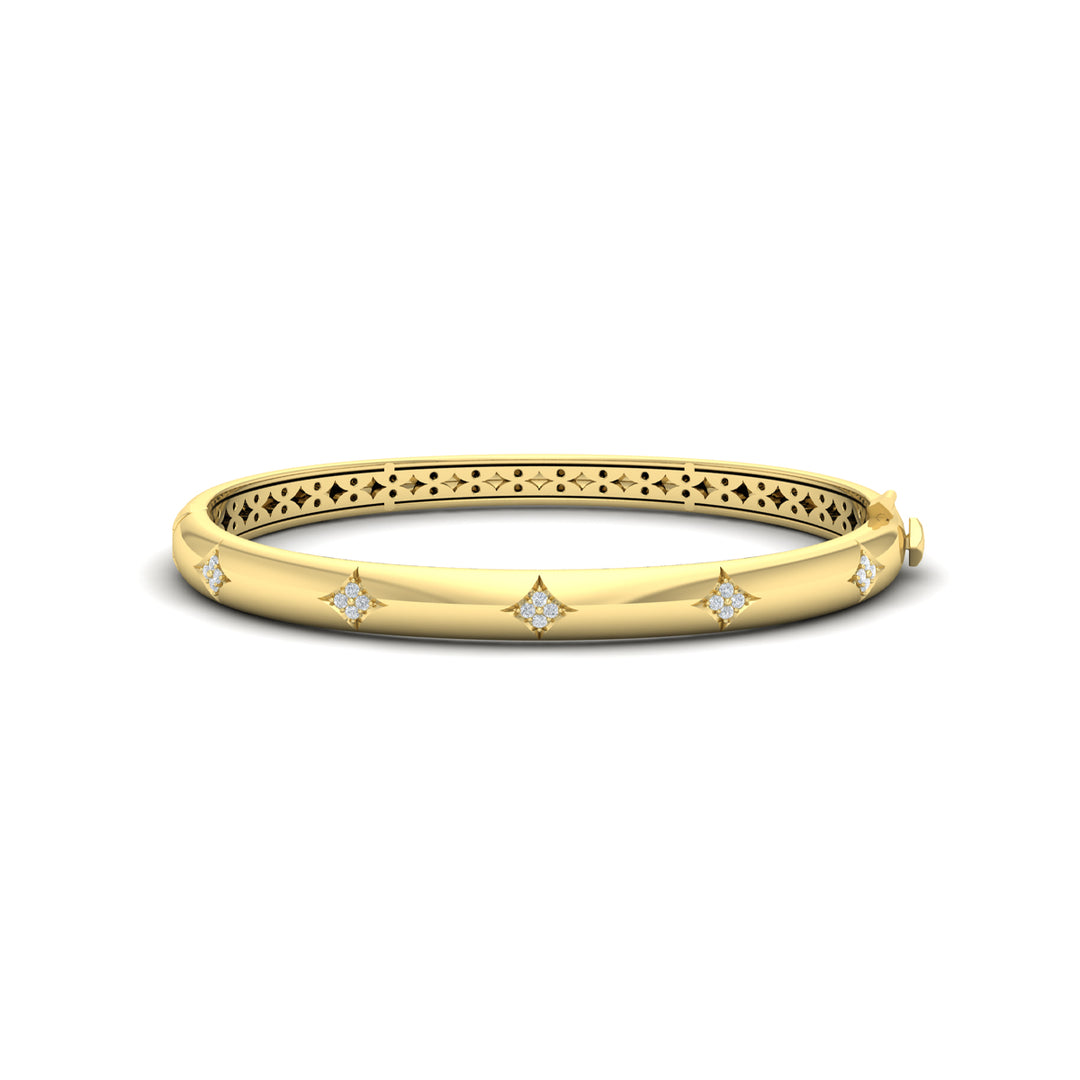 A side view of a yellow-gold bracelet is set against a white background. The bracelet features a diamond-set star design across the yellow gold bangle with a clasp.