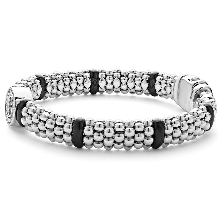 A side-view of a sterling silver bracelet in the middle of a white background featuring smooth black ceramic and diamonds in a circle motif with Caviar beading 