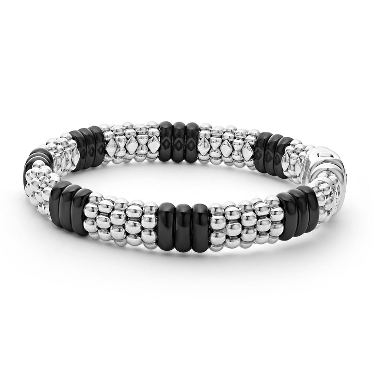 A side-view of a sterling silver beaded bracelet in the middle of a white background, featuring Sterling silver Caviar beading and smooth black ceramic