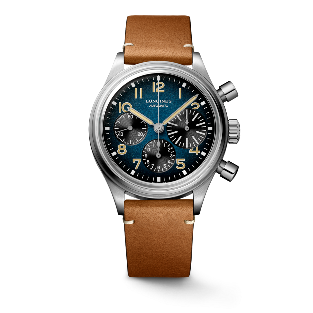 A Longines watch standing straight against a transparent background. The watch features a blue & black dial, tan & white hands and markers, a stainless steel bezel, three crowns, and a brown leather strap.