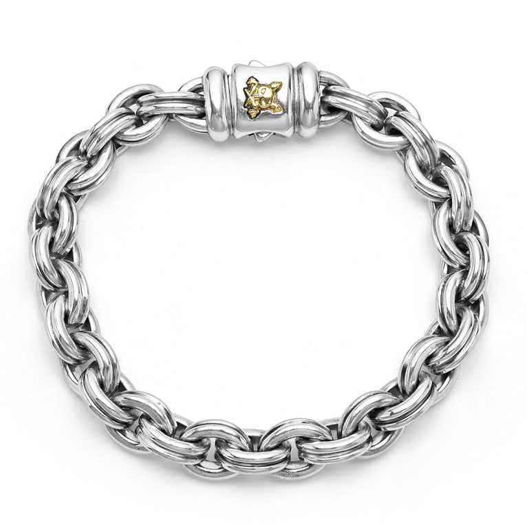 A sterling silver bracelet in the middle of a white background featuring double link chain and krunch crescent on the clasp