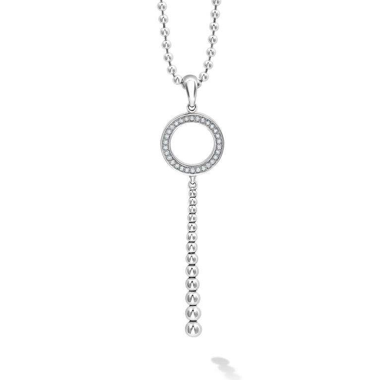 Close-up of a sterling silver necklace featuring a diamond circle pendant with a Caviar beading accent displayed on a white background.