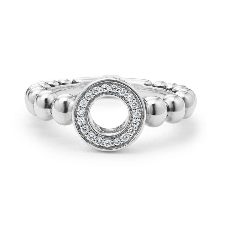 A sterling silver ring is displayed on a white background featuring diamond circle detailing the LAGOS logo sits on a tapered Caviar beaded band