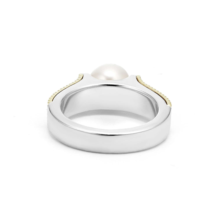 A sterling silver and 18k gold ring displayed in the middle of a white background featuring a cultured freshwater pearl and caviar beading. 