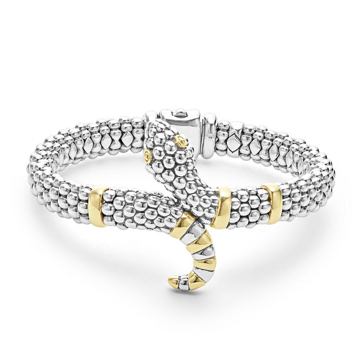 A sterling silver & 18k gold bracelet in the middle of a white background featuring a snake motif, gold stations, and sterling silver caviar beading.