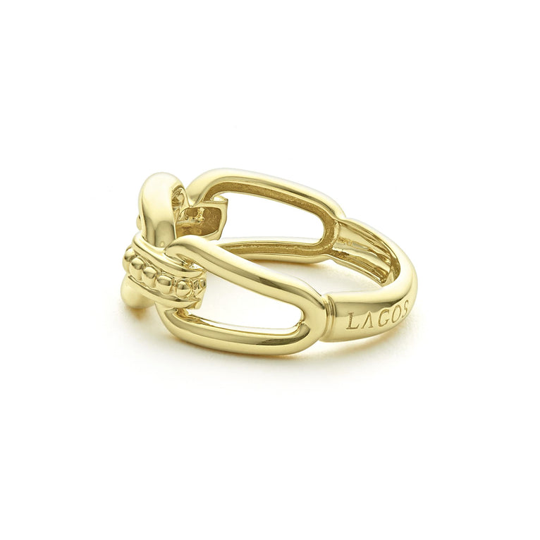 A side view of an 18K gold oval link ring in the middle of a white background features caviar beading and fluting elements.