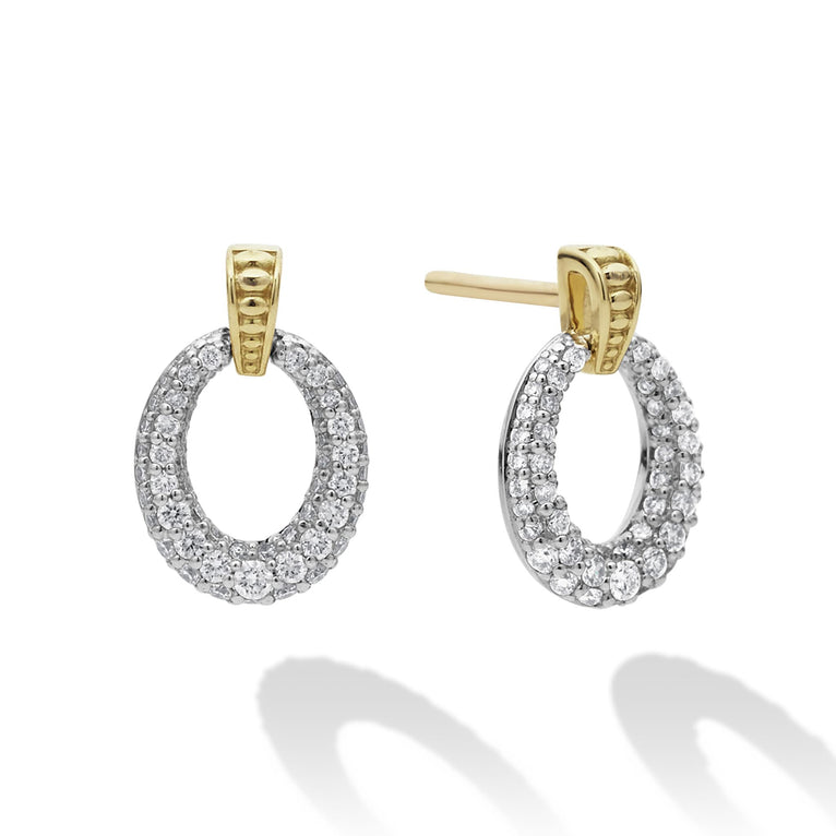 A pair of drop earrings with oval drop highlighted by 18k gold Caviar beading. The right earring is angled to the side.