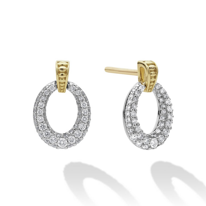 A pair of drop earrings with oval drop highlighted by 18k gold Caviar beading. The right earring is angled to the side.