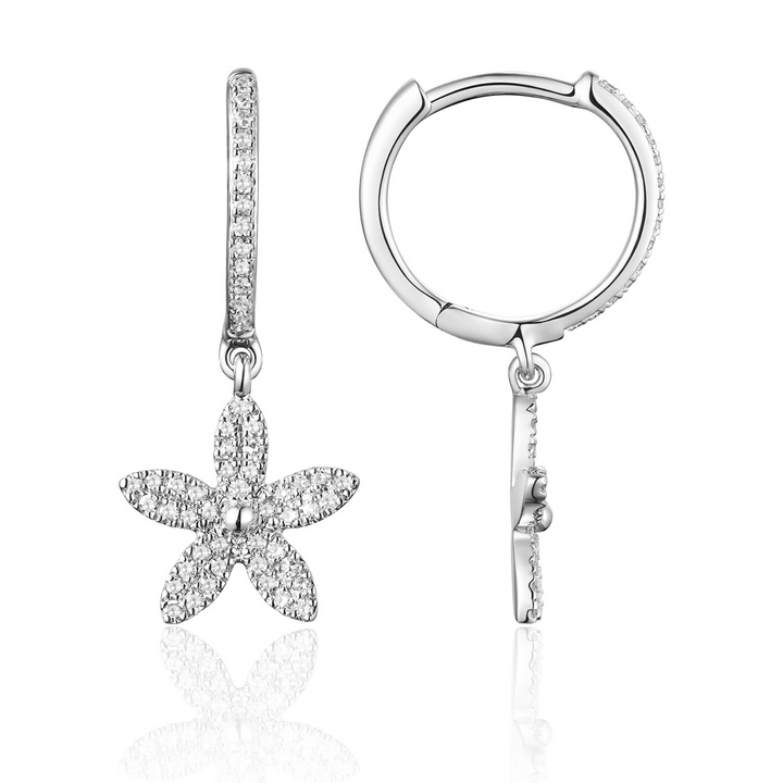 A pair of drop diamond earrings with a flower design with a cluster of diamonds. The right earring is angled to the side.