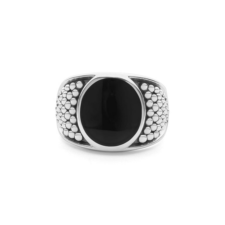 A sterling silver ring in the middle of a white background featuring a black agate gemstone and sterling silver Caviar beading