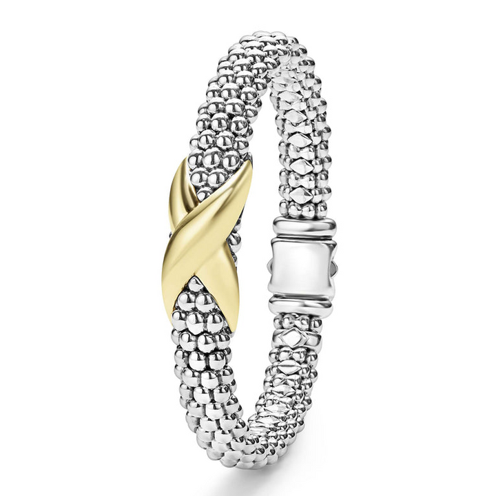 A Sterling Silver & 18k gold bracelet angled to the side against a white background. The bracelet features a gold X station, caviar beading, and a stainless steel clasp.