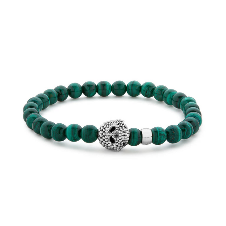 A sterling silver bracelet is displayed in the middle of a white background featuring a Malachite gemstone beaded bracelet with a sterling silver Caviar skull.