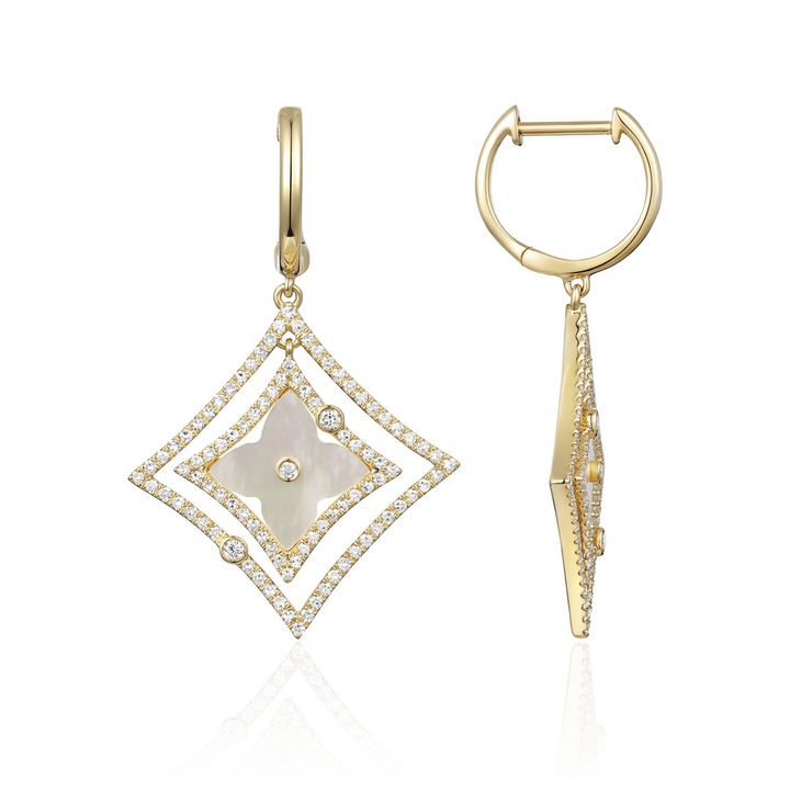 A pair of drop earrings with a mother-of-pearl Northstar motif and diamond-set halos. The right earring is angled to the side.