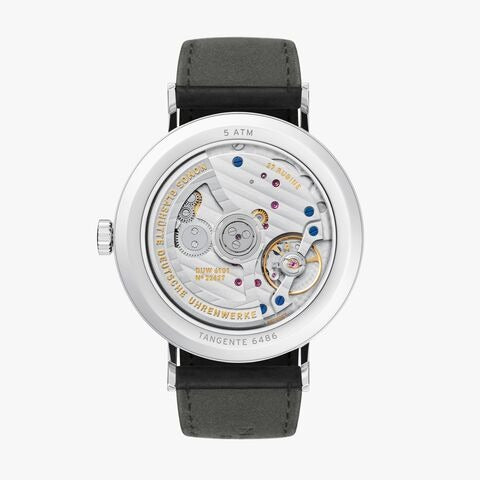 The back of a Nomos Glashutte watch showcases the back of the dial, stainless steel bezel, and strap.