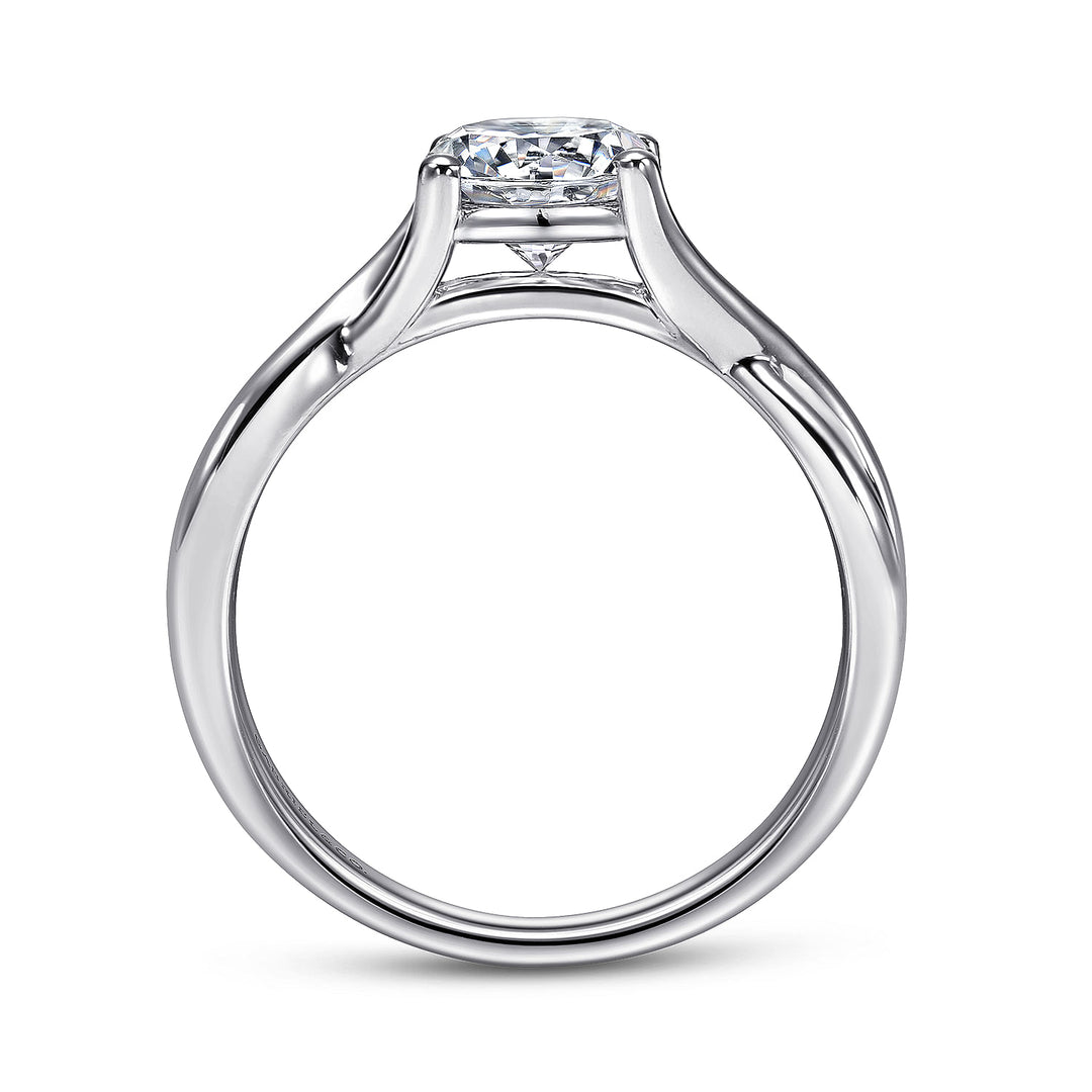 A side view of a ring made of white gold. The side view shows the diamond's pavilion and the white-gold band.