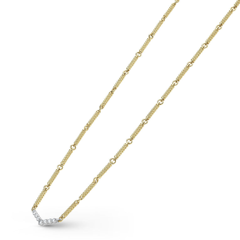 A close-up of an 18k gold necklace angled to the right, featuring caviar beading and a white gold chevron design against a white background.