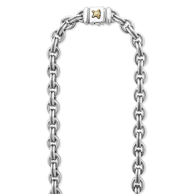 A sterling silver & 18k gold double link chain highlighting the clasp featuring a 18k gold Krunch crescent