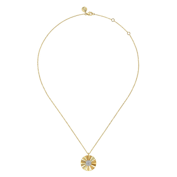 A yellow-gold Sunbeam Pendant Necklace in the middle of a white background. The necklace features a medallion design with a diamond clustered center stone.