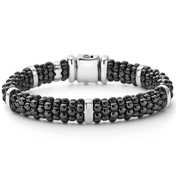 A sterling silver beaded bracelet in the middle of a white background featuring five sterling silver stations and black caviar beading