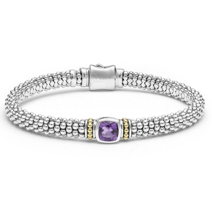 A sterling silver bracelet in the middle of a white background features an amethyst gemstone and sterling silver Caviar beading with 18K gold detailing.