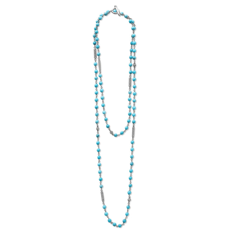 A sterling silver and ceramic beaded necklace in the middle of a white background featuring Turquoise ceramic and silver Caviar beading.