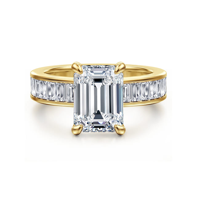 Front view of a 14K yellow gold engagement ring with an emerald cut center diamond and channel-set baguette diamond band.