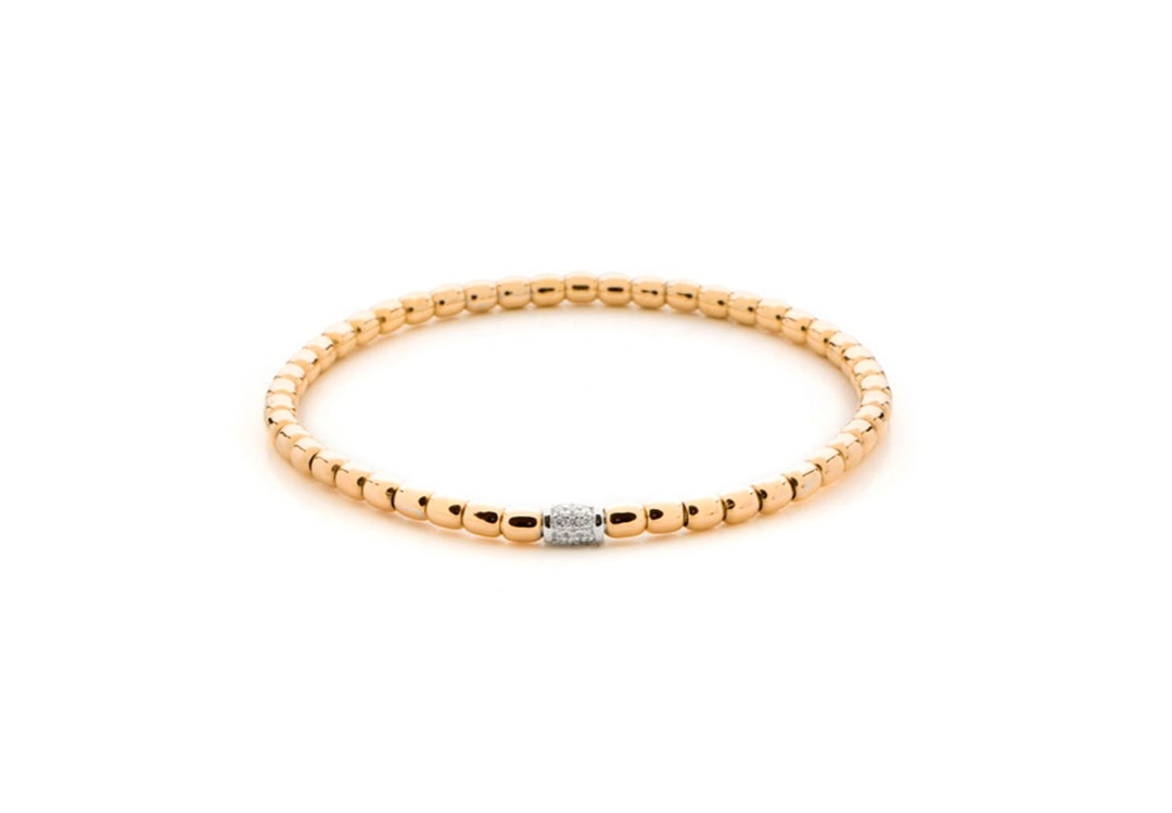 A Diamond Bead Stretch Bracelet in radiant yellow gold sitting in the middle of a white background. The bracelet features shimmering diamond-encrusted beads.