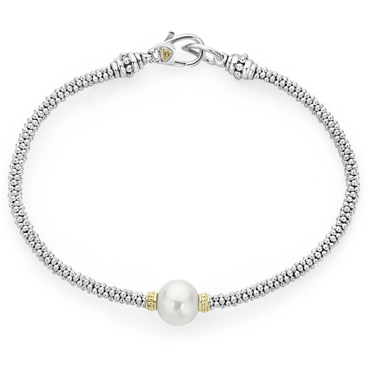 A sterling silver & 18k gold bracelet displayed in the middle of a white background featuring a cultured freshwater pearl station with Caviar beading in 18K gold and sterling silver