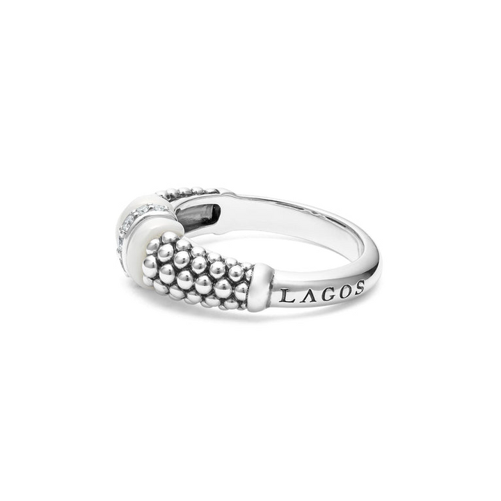 A side-view of a sterling silver ring is displayed on a white background featuring white ceramic caviar beading with a row of diamonds.