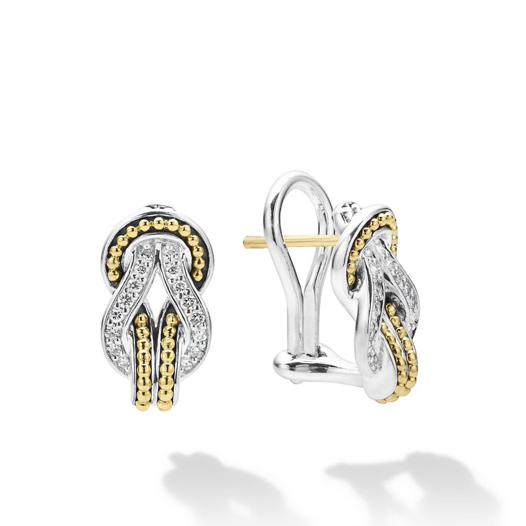 A pair of omega clip huggie earrings with diamonds and 18K gold woven in a knot motif. The right earring is angled to the side.