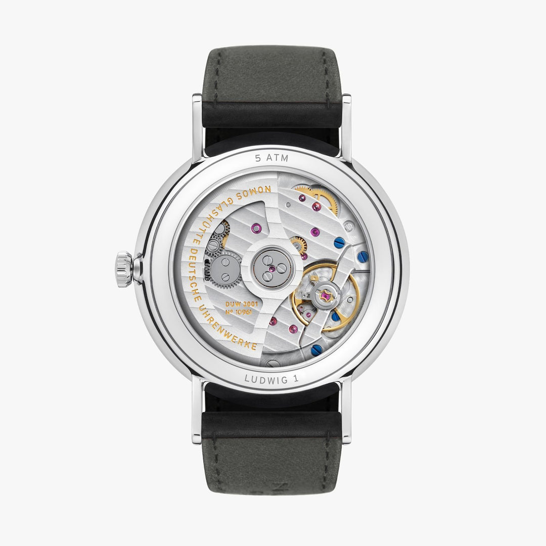 The back of a Nomos Glashutte watch showcases the back of the dial, stainless steel bezel, and strap.