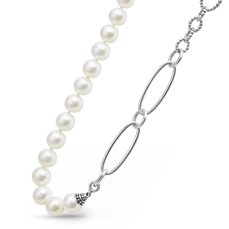 A close-up of a sterling silver & 18k gold necklace angled to the right, featuring cultured freshwater pearl stations highlighted with Caviar beading.