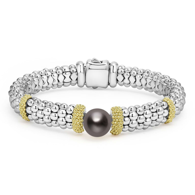 A sterling silver bracelet in the middle of a white background featuring Tahitian black pearl accented by 18K gold stations and caviar beading.