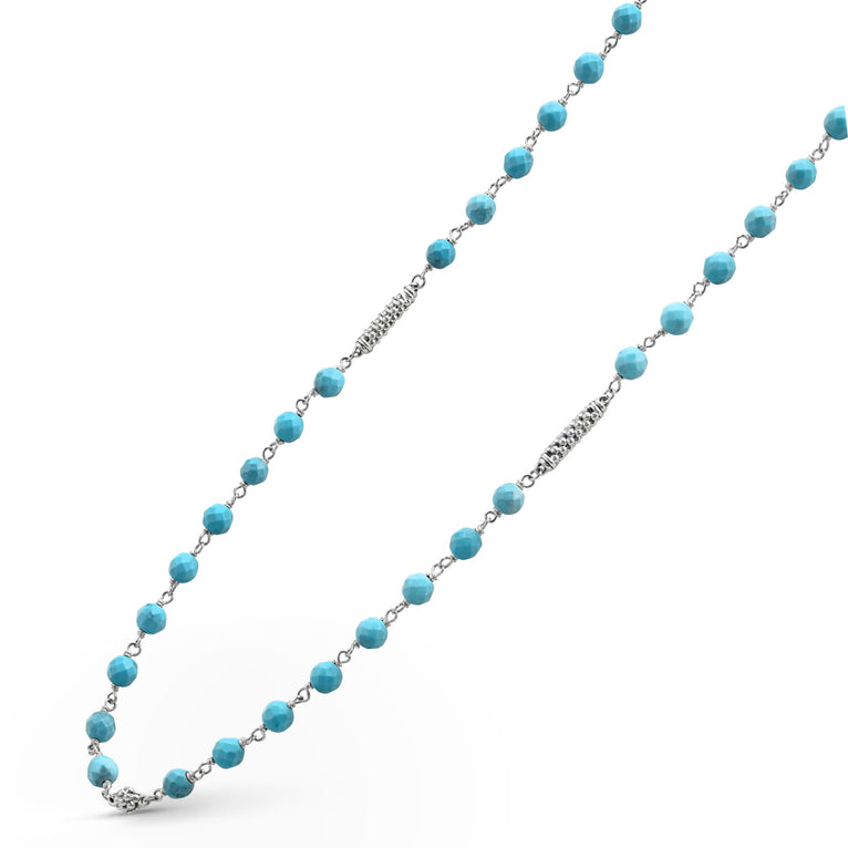 A sterling silver and ceramic beaded necklace angled to the right in the middle of a white background featuring Turquoise ceramic and silver Caviar beading.