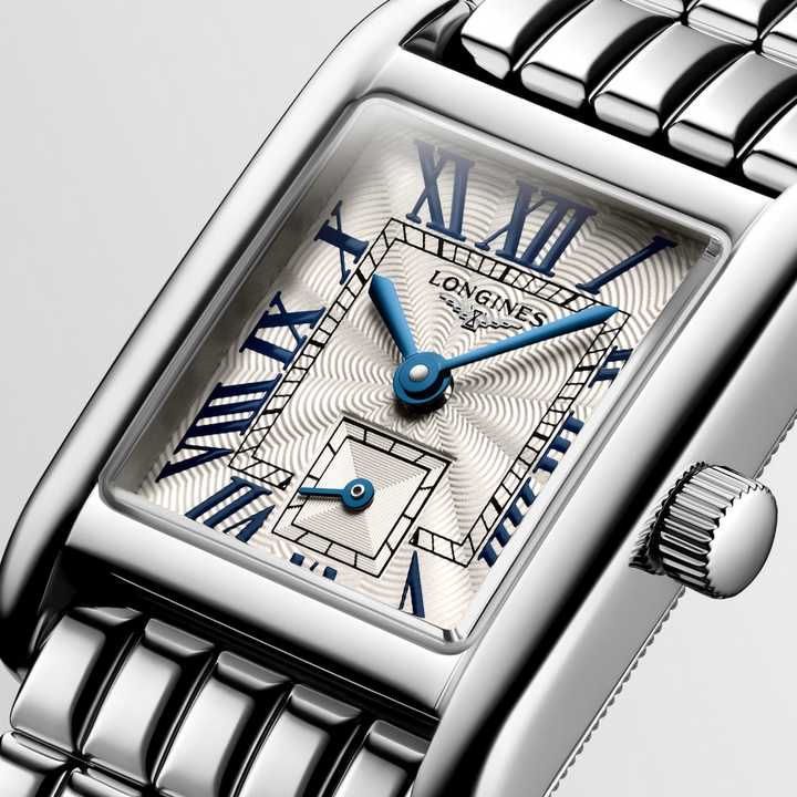 This is a close-up of a Longies watch angled to the right, showcasing the dial with a white background. The rectangular-shaped watch features a silver dial, blue hands, black markers, a stainless steel bezel, and a stainless steel bracelet.