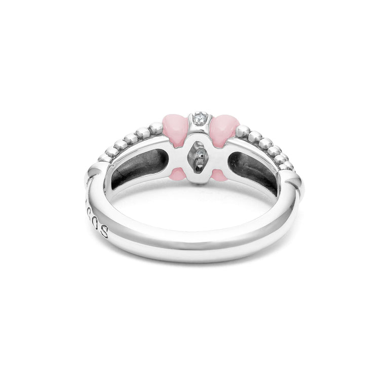 A back-view of a sterling silver ring is displayed on a white background featuring pink ceramic caviar beading with a row of diamonds.