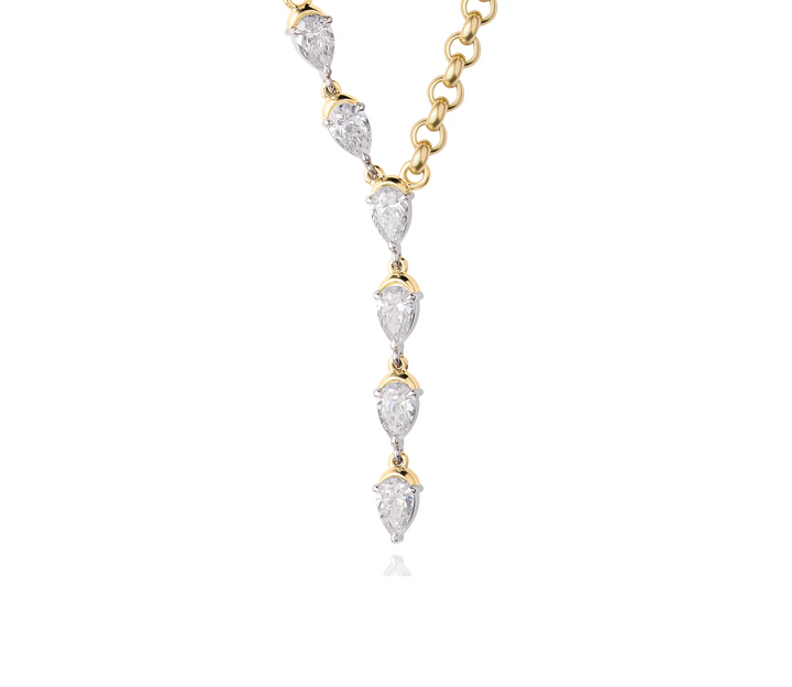 Close up of a yellow gold five station y shaped necklace with five pear shaped diamonds on a white background.