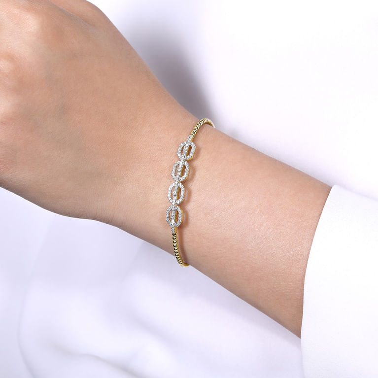 Model wearing the Gabriel & Co Bujukan Diamond Linked Bangle, showing the linked centerpiece across the wrist.