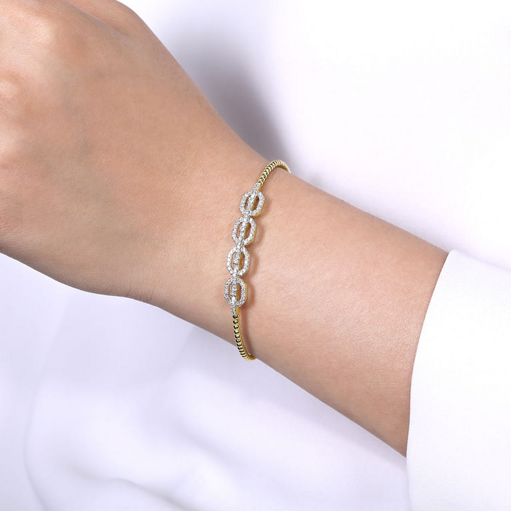 Model wearing the Gabriel & Co Bujukan Diamond Linked Bangle, showing the linked centerpiece across the wrist.