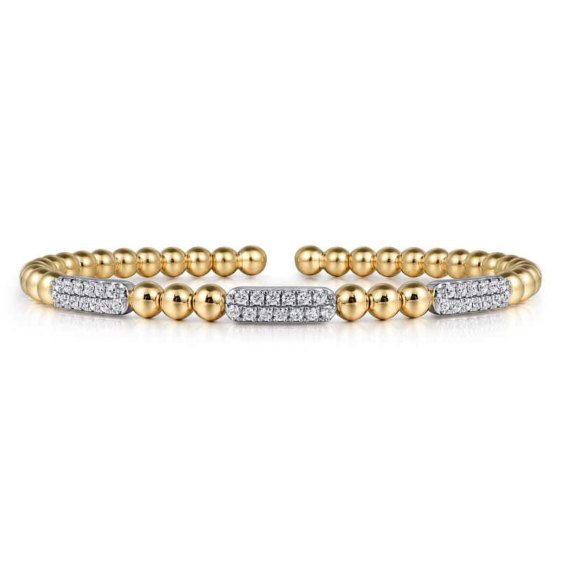 Angled view of the Gabriel & Co Bujukan bracelet showing its three diamond bars, beaded gold band and open ends.
