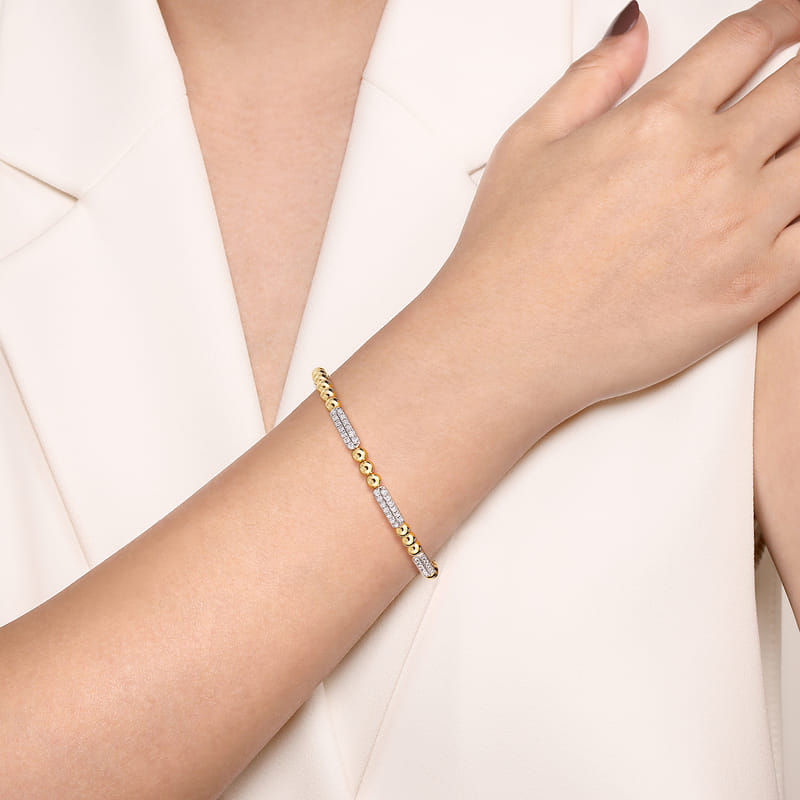 Model wearing the Gabriel & Co Bujukan diamond pavé bar bracelet, showing the three stations across the wrist.
