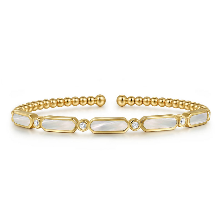 Gabriel & Co Bujukan yellow gold bangle featuring white mother-of-pearl stations, diamond accents and beaded detailing.