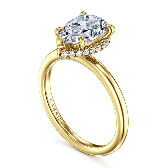 Angled view of a Gabriel & Co. pear engagement ring showing the hidden diamond halo and smooth yellow gold band.