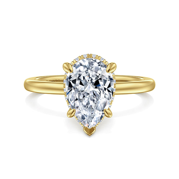Front view of a yellow gold pear diamond engagement ring with a polished band and diamond halo peeking beneath the center stone.