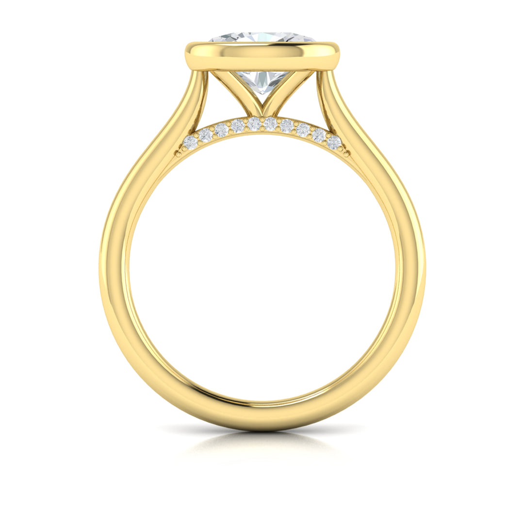 A top view of a yellow gold engagement ring is set against a white background. The engagement ring features a bezel-set east-west oval diamond center stone, cradled in a cathedral arch, and has subtle pavé detailing around the yellow gold band.