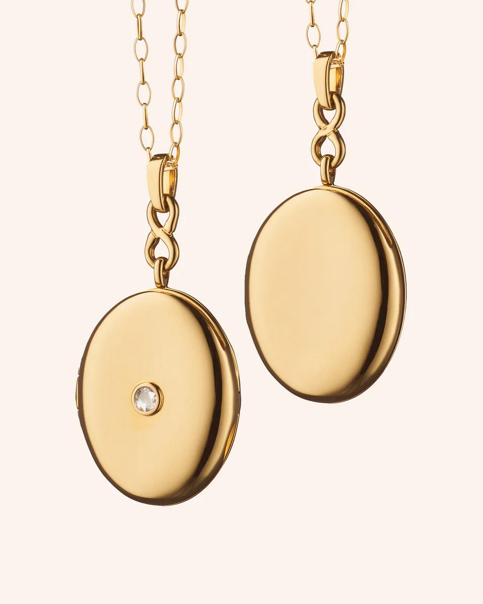 Front and back views of the Infinity 18K yellow gold locket necklace with a rose-cut center diamond